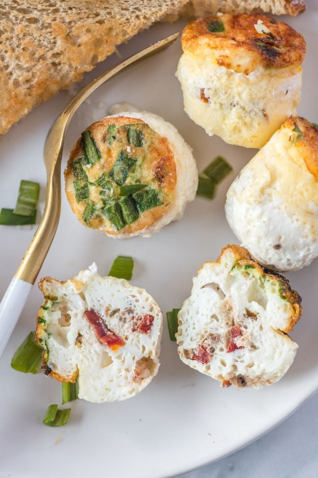 Little egg muffins served on a white plate with a side of toast