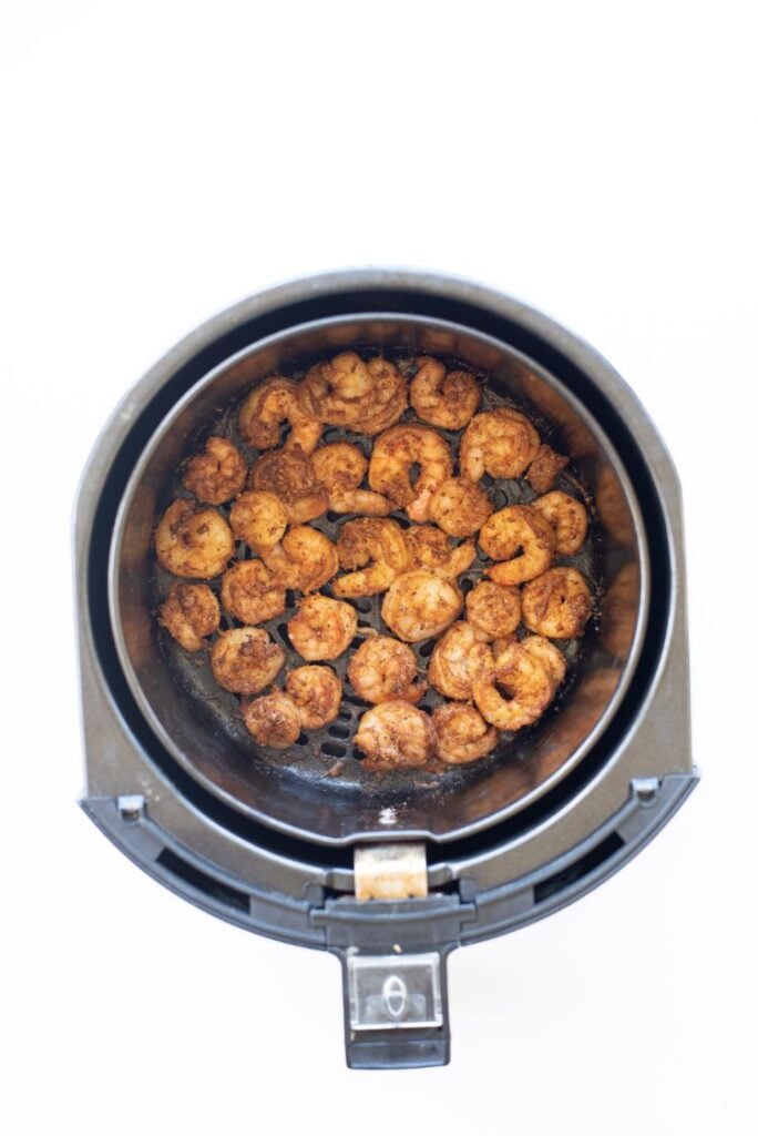 Cooked shrimp in the basket of an air fryer