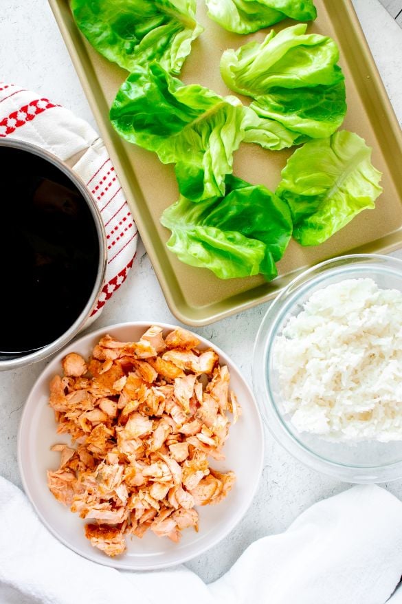 Overhead shot of homemade teriyaki sauce, leftover salmon, lettuce cups and rice