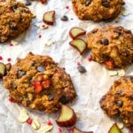 up close shot of rhubarb cookies with scattered rhubarb and chocolate chips surrounding them