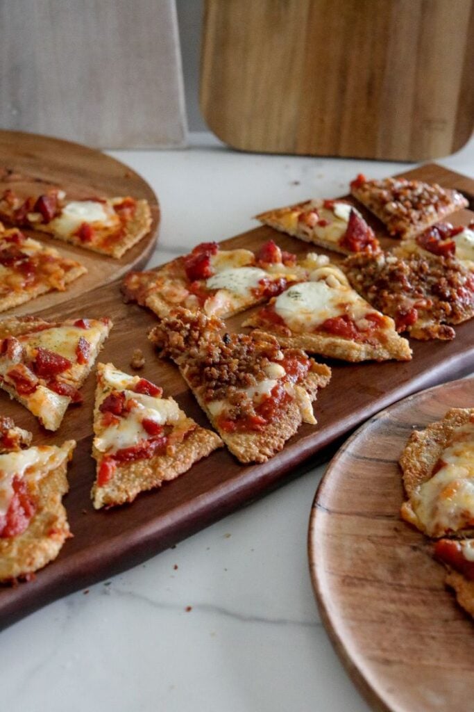 slices of chicken pizza crust served on a wooden board