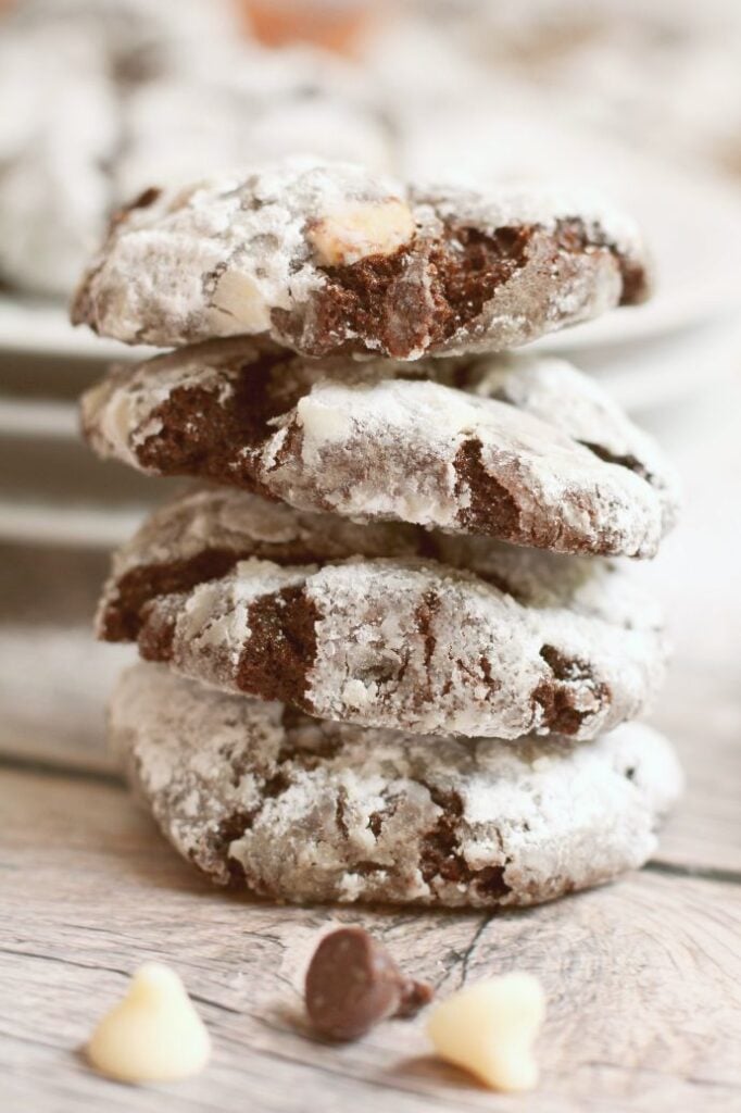 Up close frontal shot of 4 chocolate peppermint crinkle cookies stacked one on top of the other