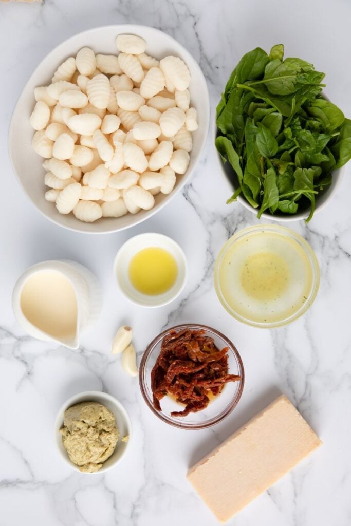 Overhead ingredient shot of all ingredients needed to make a creamy gnocchi dish