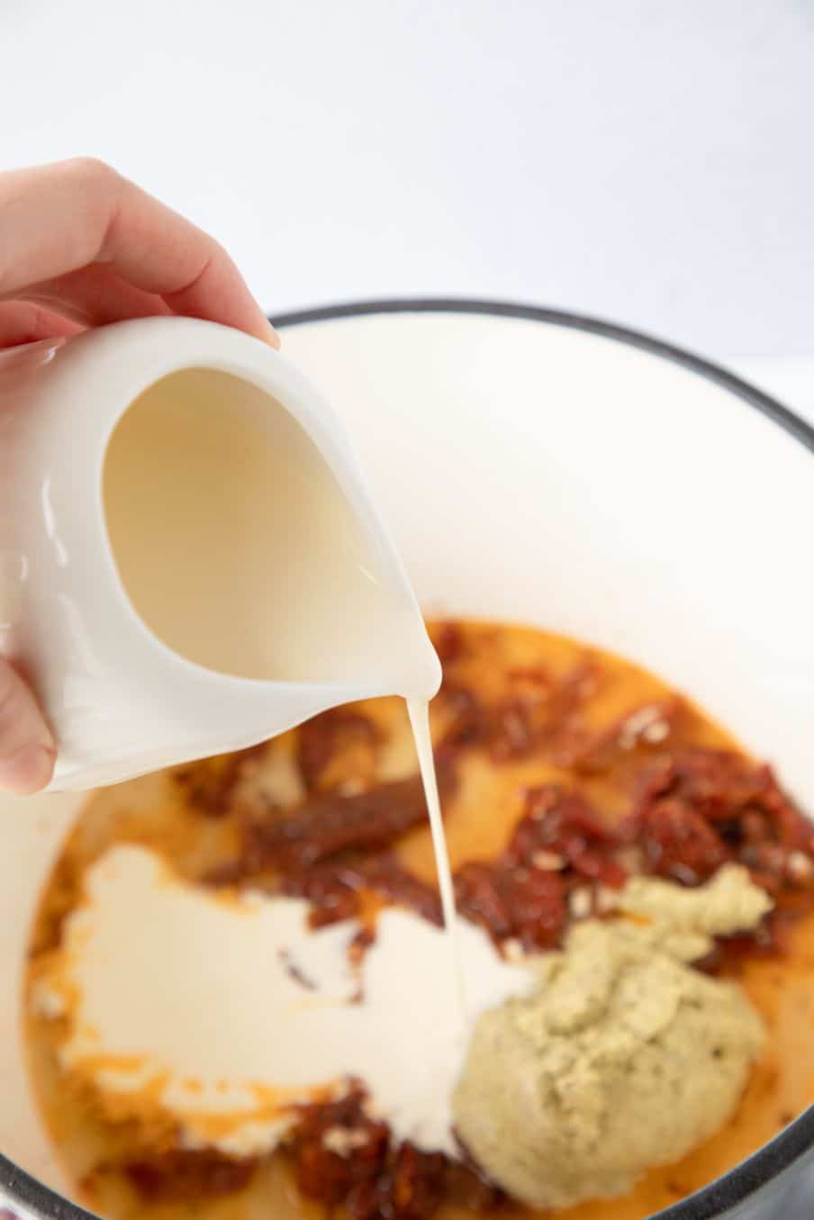 process shots for preparing a creamy pesto sauce to pair with potato gnocchi