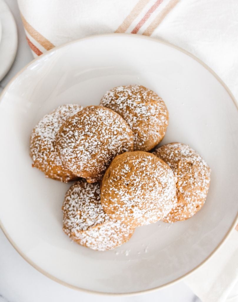 a stack of pumpkin cookies served on a white plate