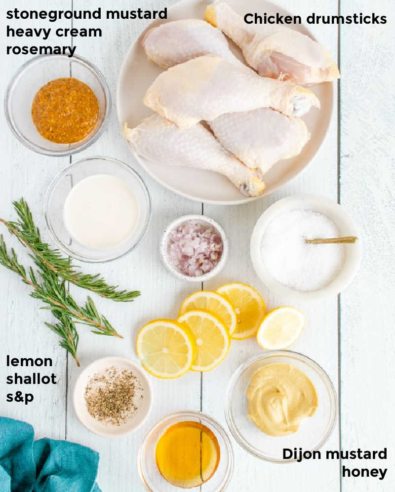 Overhead shot of all ingredients needed for honey mustard chicken drumsticks served in small bowls