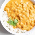 overhead shot of pumpkin curry served with rice and cilantro