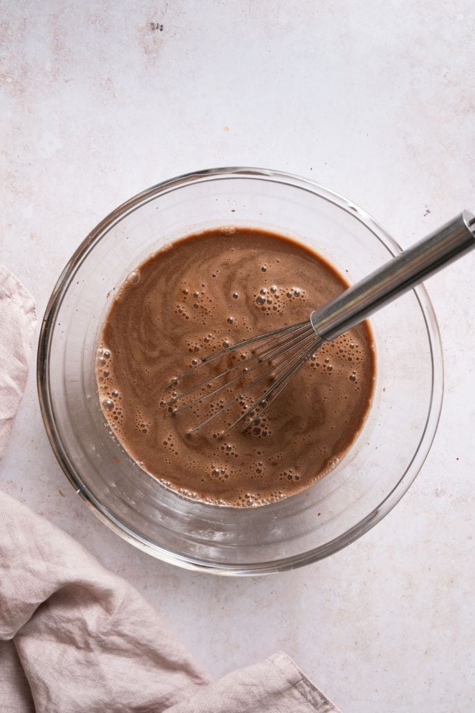 large glass bowl containing a liquid chocolate mixture