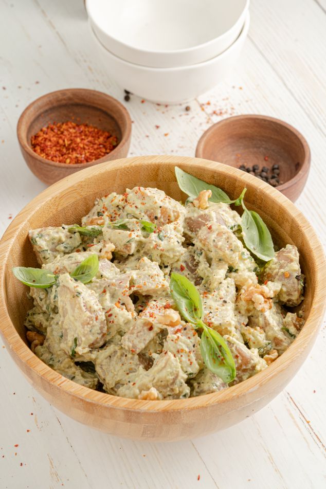 Potato salad with pesto served in a wooden serving bowl