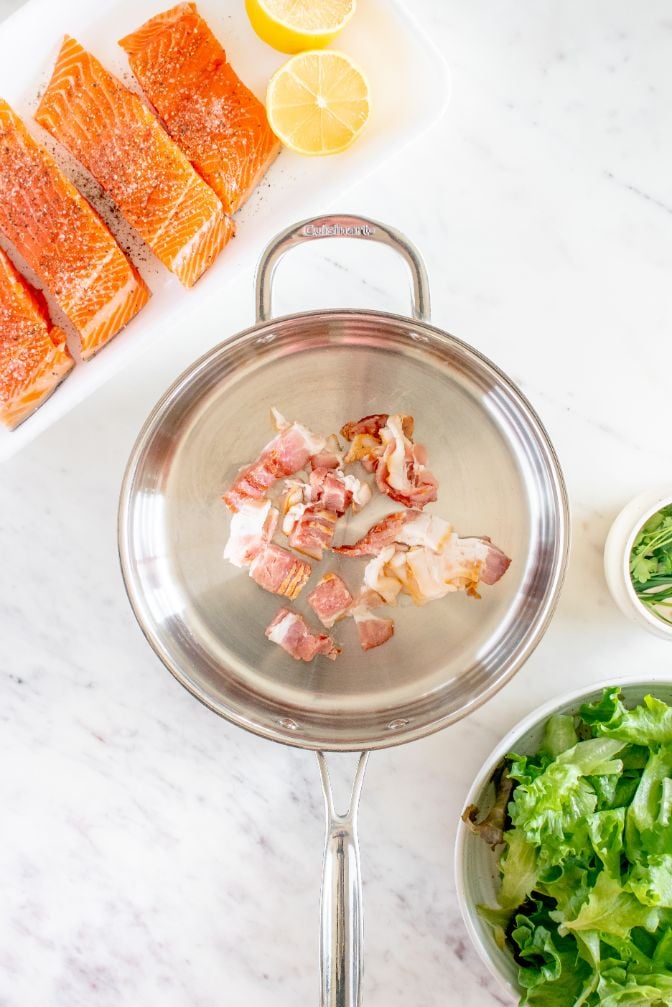 Bacon being cooked in a large saucepan