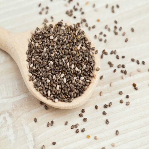 Chia seeds sitting in a wooden spoon