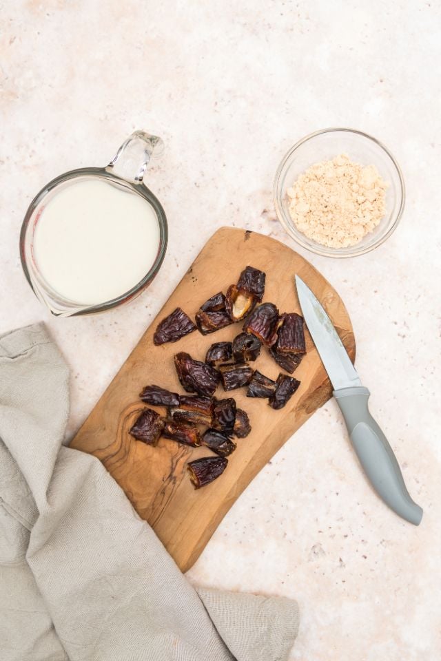 chopping dates on a chopping board to remove the pit inside