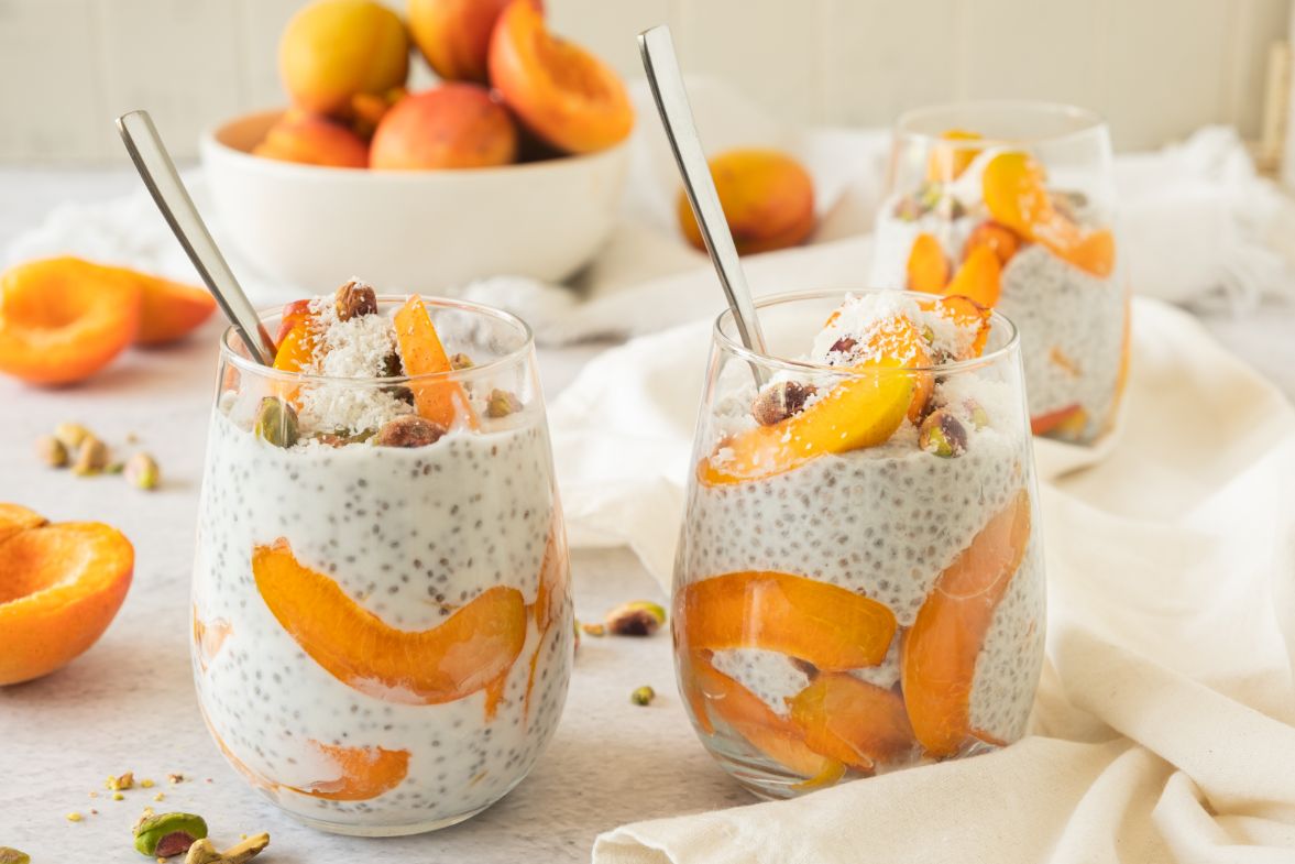 chia pudding served in a glass with fresh apricots
