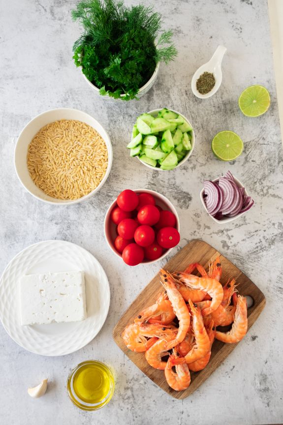 Overhead shot of all the ingredients needed for a cold orzo shrimp salad