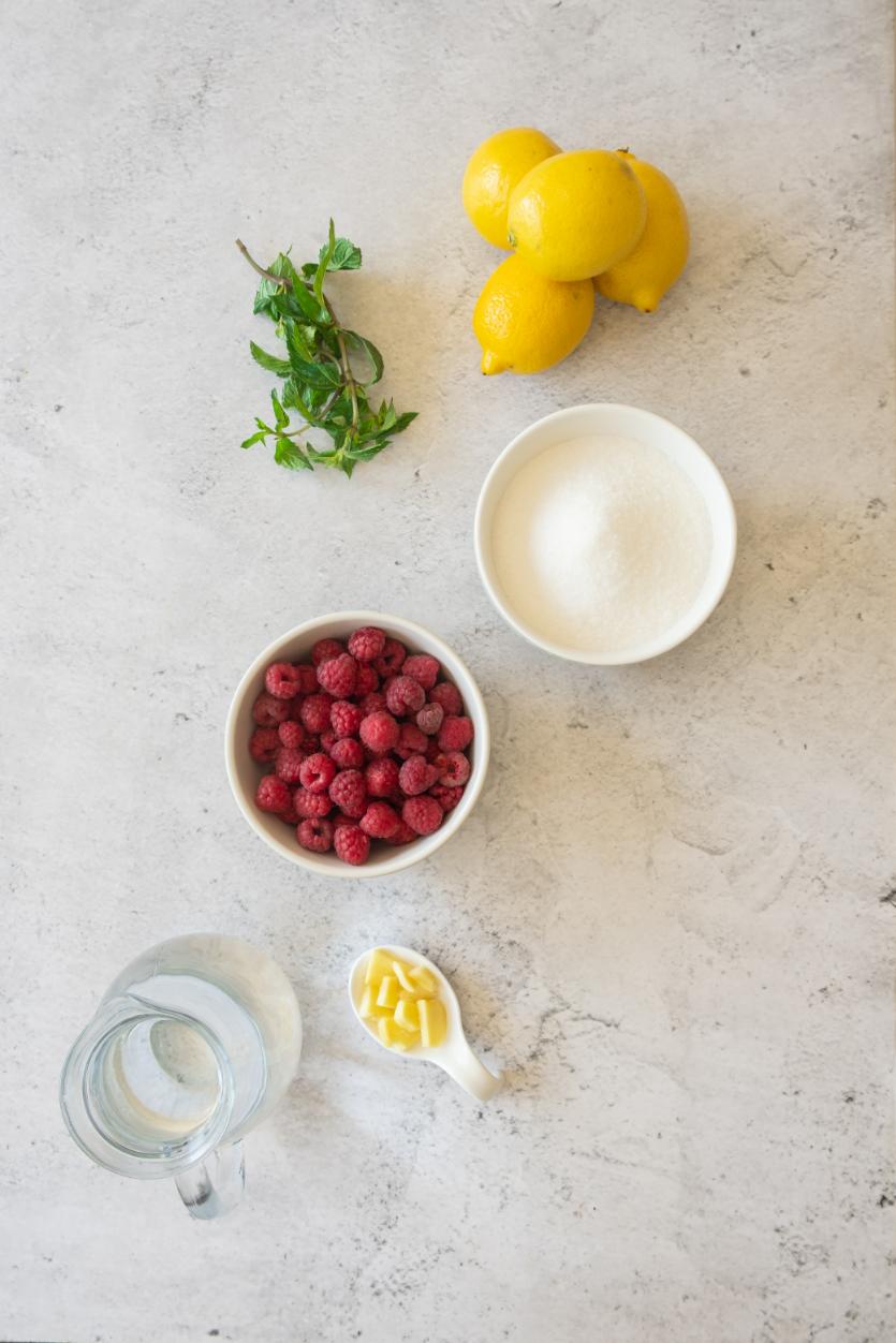 An overhead shot of ingredients used for making homemade lemonade all served in small bowls