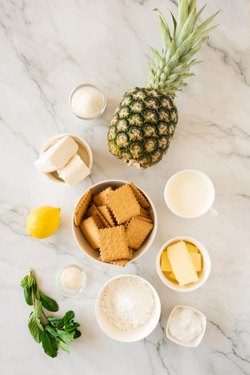 An overhead shot of ingredients for making a pineapple cheesecake