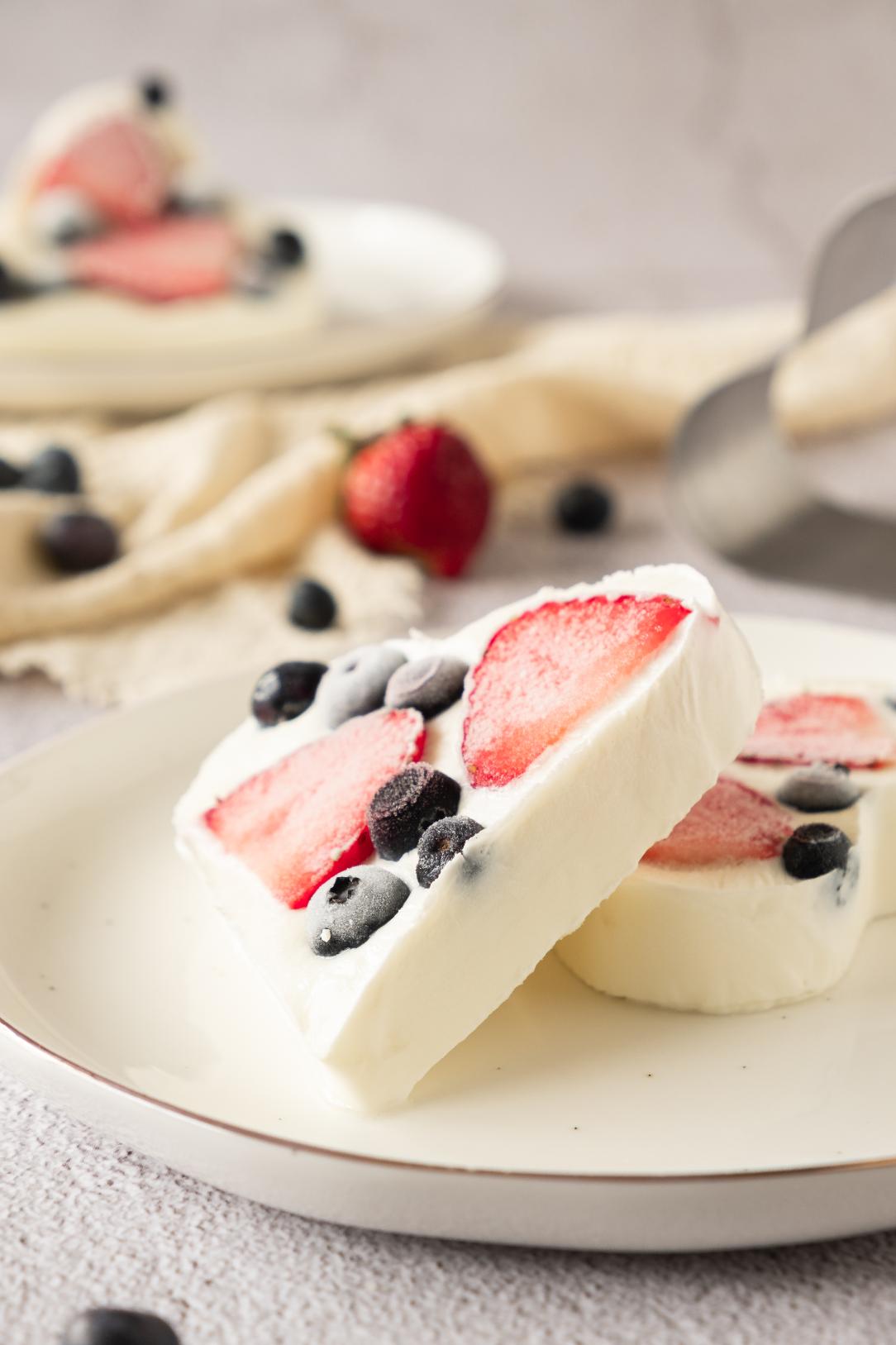 An up close shot of two heart shaped yogurt barks served on a white plate