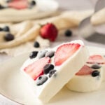 Heart shaped frozen yogurt bites topped with blueberries and strawberries