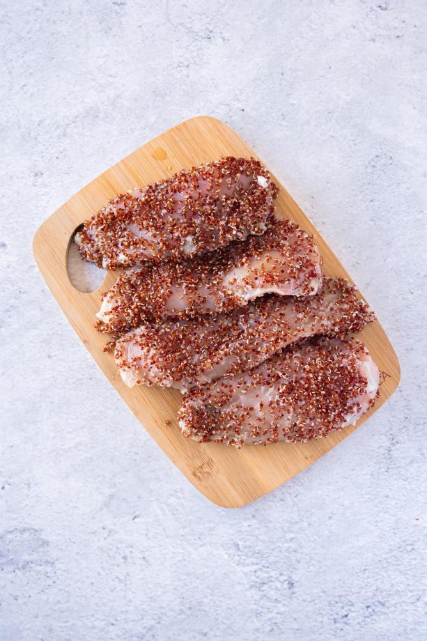 Photo of chicken breasts coated in red quinoa