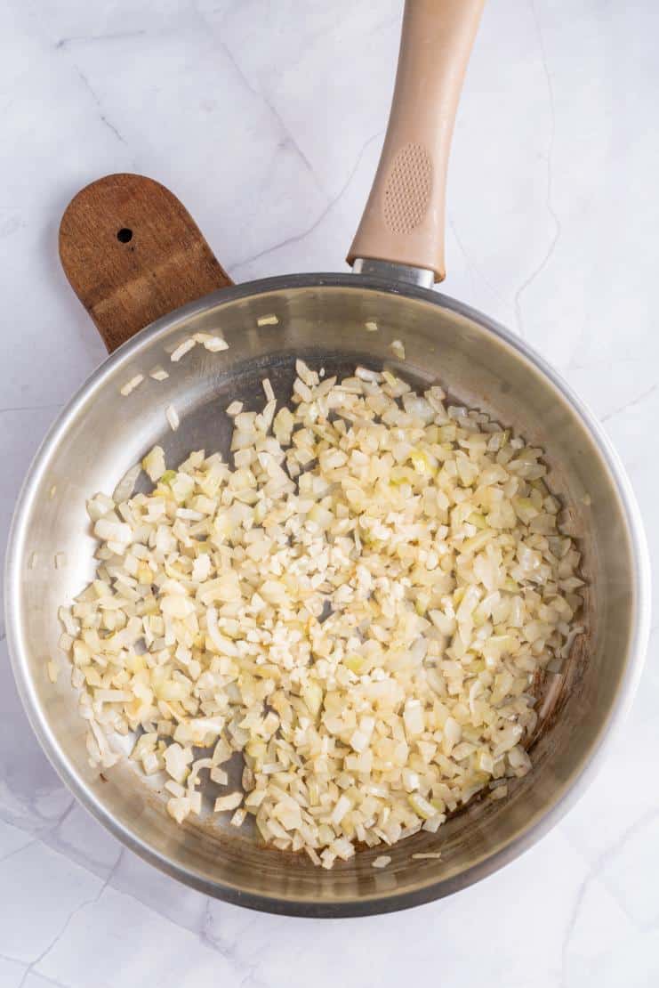 Onions and garlic cooked in a saucepan until fragrant and slightly browned