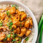Quick and easy chicken cashew stir fry served in a white bowl with steamed rice
